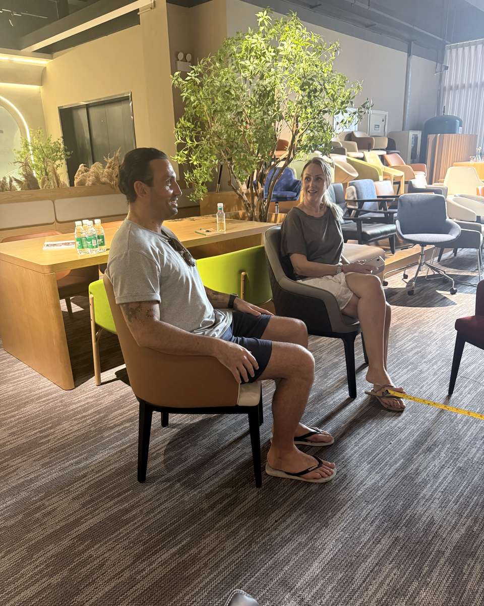 Trade visitors comparing upholstered chair options at Mingyi